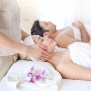 A beautiful woman slept with eyes and massage the face and head at the spa.